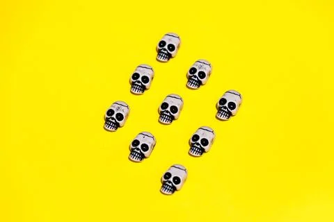 Set of illustrated skull composing rhomb on yellow backdrop Stock Illustration