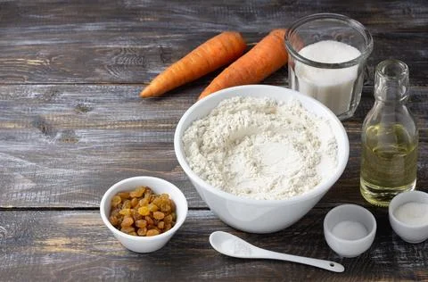 Set of ingredients for carrot cake on rustic wooden table: flour, sugar, ca.. Stock Photos