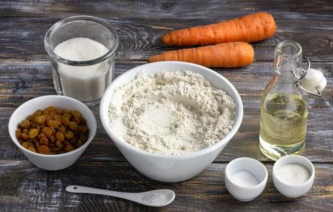 Set of ingredients for carrot cake on rustic wooden table: flour, sugar, carrots Stock Photos