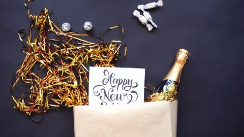 A set of items for the New Year party are moving on a black table. Stockbeeldmateriaal 82313558