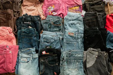 Set of jeans of different sizes and colours for sale on the street of Bangkok Stock Photos