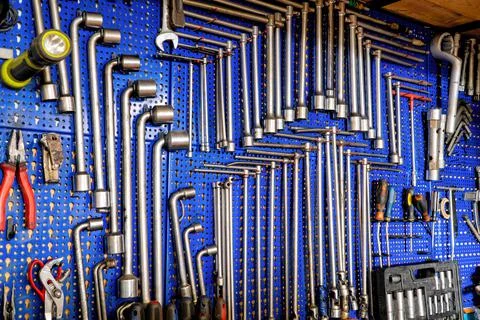 A set of keys and tools from the machine shop. Hanging on blue backdrops with Stock Photos