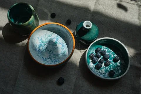 Set of kitchen ceramic tableware on a table. Eco style home still life. Stock-Fotos