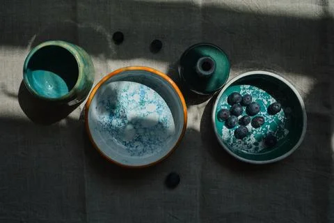 Set of kitchen ceramic tableware on a table. Eco style home still life. Stock Photos