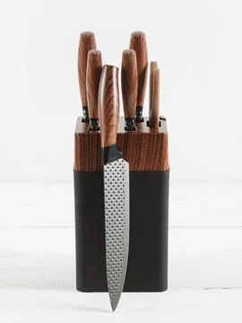 Set of kitchen knives on a stand. White background. Stock Photos