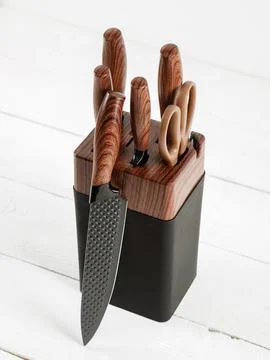 Set of kitchen knives on a stand. White background. Stock Photos