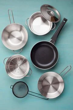 Set of kitchen metallic pans. Mockup, kitchen utensils, recipe book and coo.. Stock Photos
