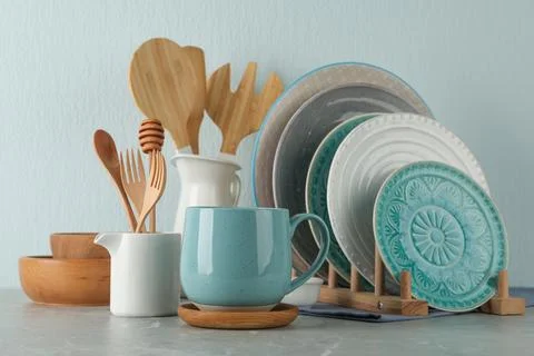 Set of kitchenware on grey marble table near light wall. Modern interior desi Stock Photos