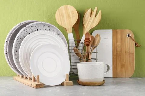 Set of kitchenware on marble table near green wall. Modern interior design Stock Photos