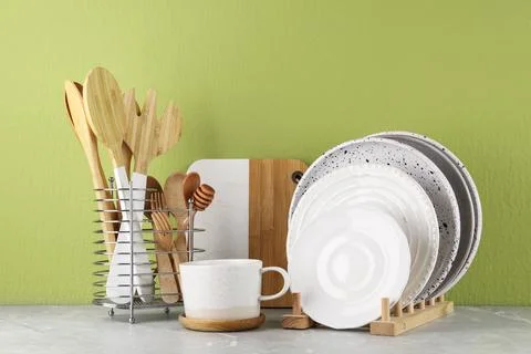 Set of kitchenware on marble table near green wall. Modern interior design Stock Photos