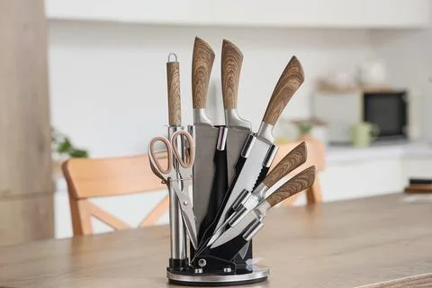 Set of knives on table in kitchen, closeup Stock Photos