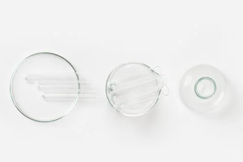 A set of laboratory glassware on a light background. Petri dishes, flasks, cu Stock Photos