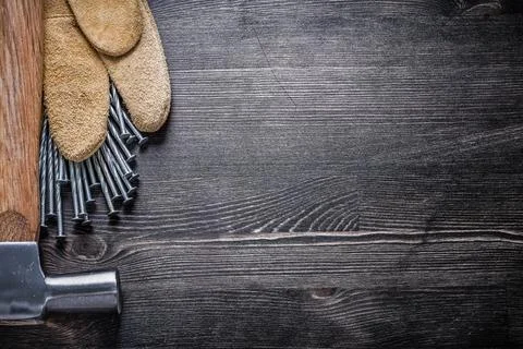 Set of leather protective gloves construction nails claw hammer. Stock Photos
