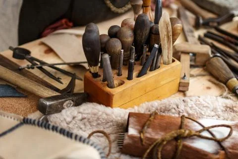 Set of leather working tools on working desk Stock Photos
