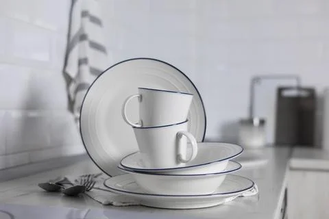 A set of light dishes on the background of a kitchen interior Stock Photos