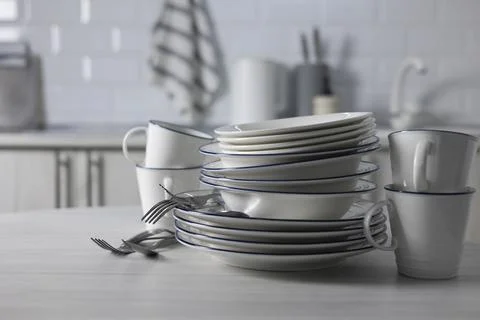 A set of light dishes on the background of a kitchen interior Stock Photos