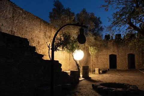 Set of light with round shade lamp in the night. Stone walls of San Jorge Castle Stock Photos