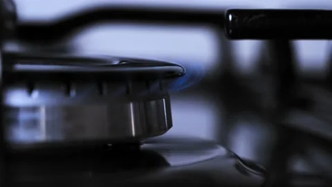 Set lower flame of kitchen stove. To use less gas to cook, cook on low heat.  Stock Footage 212046514