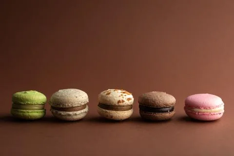 Set macarons close-up on brown background Stock Photos