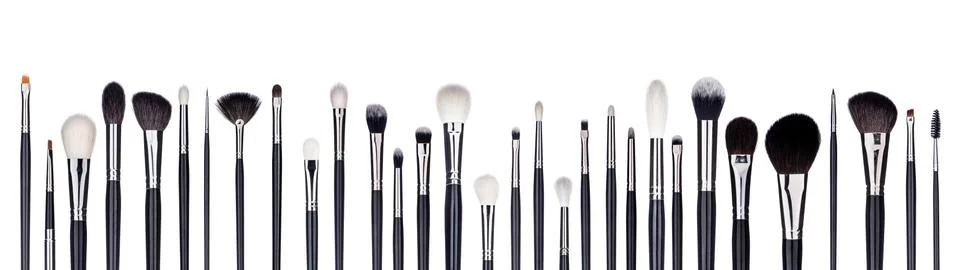 Set of make-up brushes lined up in alternating pattern. Isolated on white Stock Photos