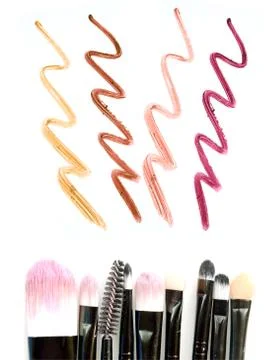 Set of make-up brushes with lipstick trace isolated on white background. Stock-Fotos