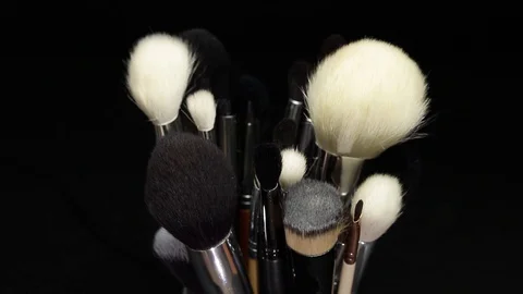 Set of makeup brushes on a black background. Makeup brushes rotate. Stock Footage 128191112