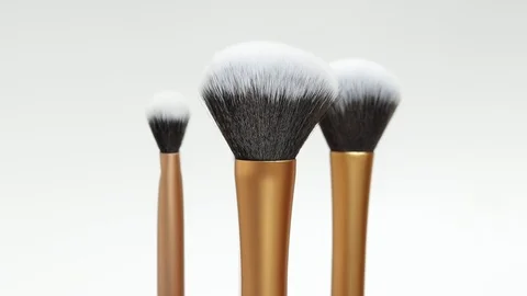 A set of makeup brushes rotates on a white background. Brushes close-up. Stock Footage 127504333