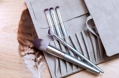 A set of makeup brushes of various shapes lies on the makeup artist's table. Stock Photos