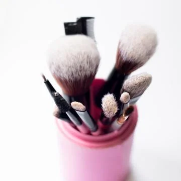 Set of makeup pink brushes on white background. Top view point, flat lay Stock Photos