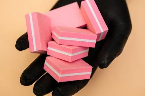 A set of manicure nail files with the same abrasive in the hand of the manicure Stock Photos