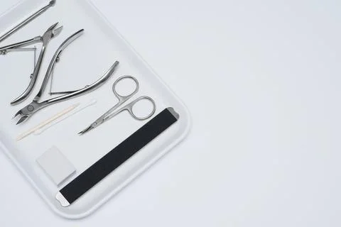 Set of manicure scissors, clipper, spatula, for nail care on a grey background 스톡 사진