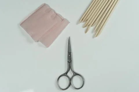 A set of manicure tools including scissors and orange cuticle sticks. Stock Photos