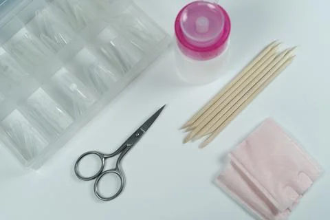 A set of manicure tools, including scissors, on a white background. Stock Photos