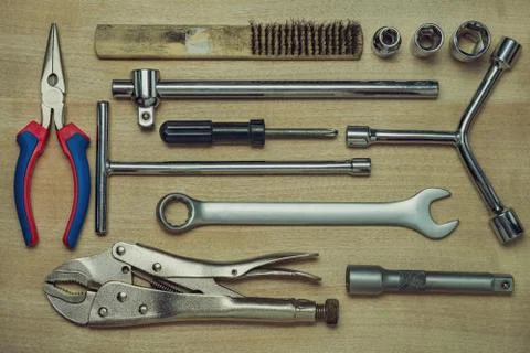 Set of many hand tools on brown wooden floor. Stock Photos
