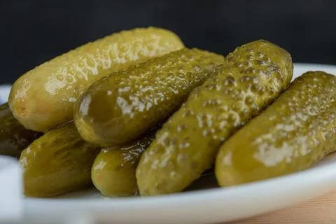 Set of marinated cucumbers on white plate Stock Photos