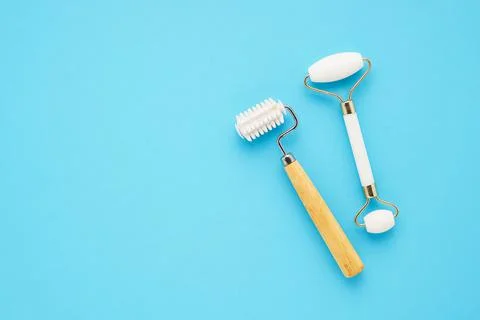 Set of massage rollers for face on blue background. Skincare concept. Copy space Foto stock