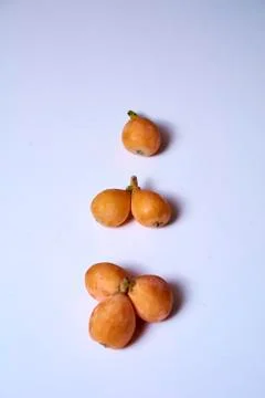 Set of medlars in order on white table Stock Photos