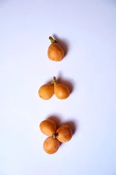 Set of medlars in order on white table Stock Photos