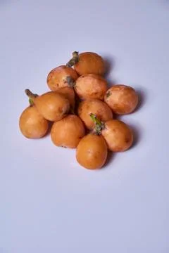 Set of medlars in order on white table Stock Photos