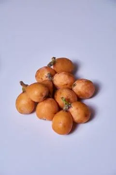 Set of medlars in order on white table Stock Photos