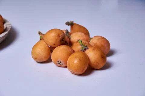 Set of medlars in order on white table Stock Photos