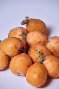 Set of medlars in order on white table Stock Photos