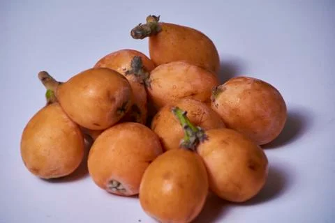 Set of medlars in order on white table Stock Photos
