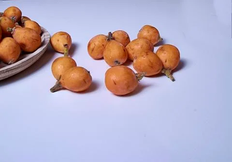 Set of medlars in order on white table Stock Photos