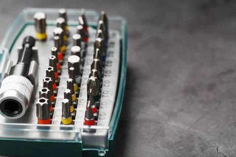 A set of metal bits for screwdrivers in a box. Hexagon head of different size Stock Photos