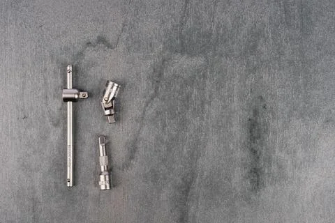 Set of metal drill bits and adapters on gray surface Stock Photos