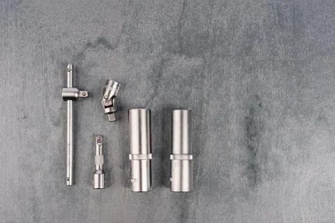 Set of metal socket wrench attachments on gray surface Stock Photos