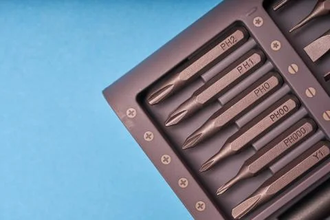 A set of miniature bits for the screw driver on blue background Stock Photos