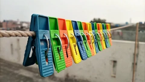 Set of multi color plastic clothes pins or clothes pegs for house hanging  Stock Footage 306339894