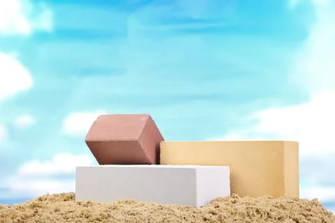 Set of multi-colored ceramic bricks on the sand at the blue sky background Stock Photos
